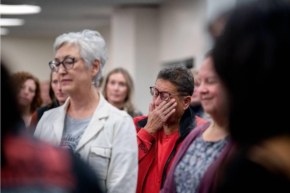 The audience during the travel song at the end of the program, one person wiping tears away